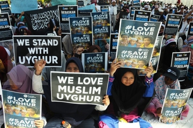 ILUSTRASI. Umat muslim yang tergabung dalam Aceh Solidaritas Untuk Muslim Uighur (ASUMU) membentang poster dan spanduk saat menggelar aksi damai di halaman Masjid Raya Baiturrahman, Banda Aceh, Jumat (21/12/2018).